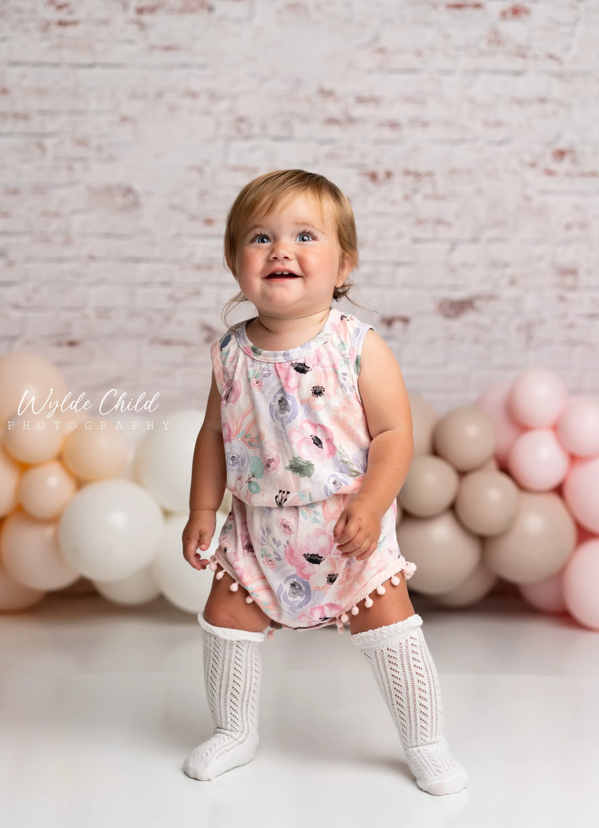 Baby Girls Rainbow Floral Mauve & Peach Pom Pom Romper